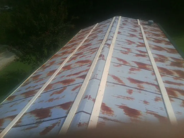 Rusted metal roof panels with new wood purlins before replacement — Storm Damage Roof Repair in Thompsons by Roofing Brothers
